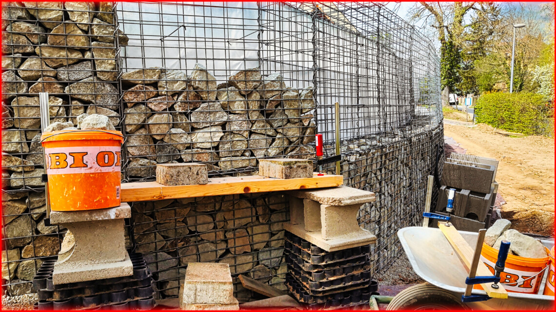 Building a gabion wall - filling the 2nd row of baskets with stones