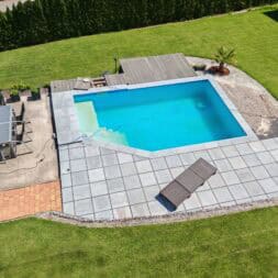 An aerial view of a backyard with a swimming pool