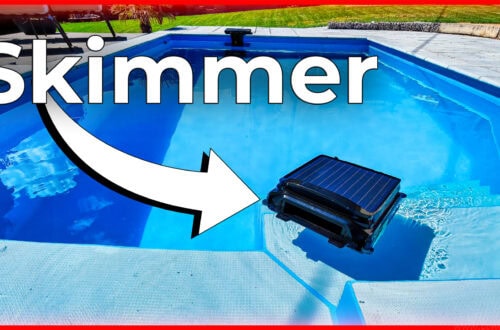 Ein WYBOT F1 Skimmer schwimmt auf der klaren blauen Oberfläche eines Außenpools, hervorgehoben durch einen Pfeil und den fetten Text "Skimmer". Die Szene zeigt erstklassige Poolpflege, mit Terrasse und Gras, die das einladende Wasser umgeben. www.commaik.de