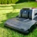 Lymow One in test: Robot mower without boundary wire with RTK navigation and chain drive 65 A Lymow One robotic lawnmower with tank-like tracks sits on a well-manicured lawn, surrounded by green grass and some fuzzy bushes in the background. www.commaik.de
