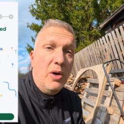 Lymow One Plus in test: RTK robot mower for large areas & difficult terrain 26 A man outdoors next to a wooden fence and stacked pallets looks into the camera. Next to it, the screen of a Lymow One Plus phone displays Wi-Fi Connected Successfully! with confetti and a green Wi-Fi symbol. www.commaik.de