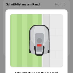 TerraMow V1000, V600, and Mini 500 Review: Robotic Lawn Mowers Without RTK and Lidar? 48 A smartphone screen shows a robotic lawn mower app in German that displays settings for the edge mowing distance, accompanied by an image of a robotic lawn mower mowing close to the edge of the lawn. Below are options to cancel or save. www.commaik.de