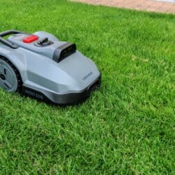 TerraMow V1000, V600, and Mini 500 Review: Robotic Lawn Mowers Without RTK and Lidar? 28 A small gray robotic lawn mower called the MINI 500 is in use on a green lawn near a brick path; its design is similar to that of the Terramow V1000, which was featured in recent test reports. www.commaik.de