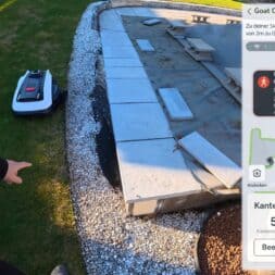 ECOVACS GOAT O1200 LiDAR PRO Review: Perfect Edge Mowing Without Any Touch-Ups? 47 A person is pointing at an Ecovacs Goat robotic lawn mower near a patio. The screen displays a warning about a detected person, statistics on edge cutting, and instructions in German regarding robot safety. www.commaik.de